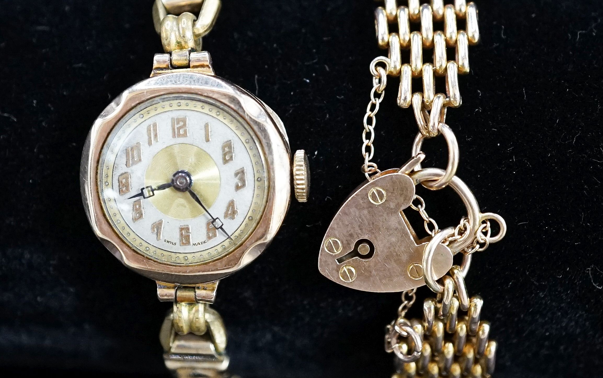 A 9ct. yellow gold chain bracelet, 9.7 grams and a lady's 9ct gold watch on a 9ct and metal core bracelet.